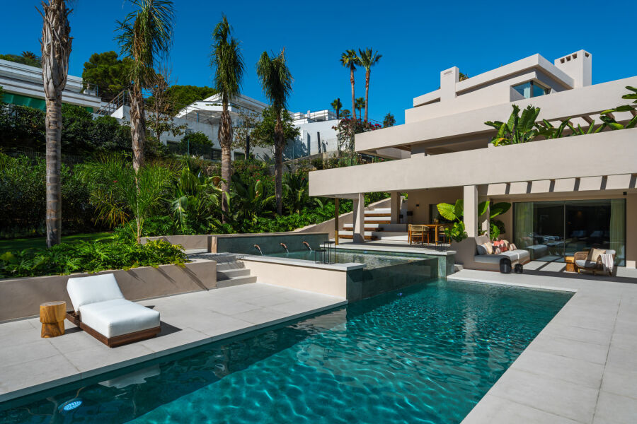 Villa in Nueva Andalucia, Marbella with poolside terrace, loungers and palm trees