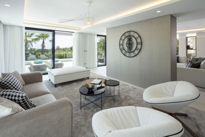 Bright living room in a villa in Nueva Andalucia, Marbella, with sliding glass doors to the terrace